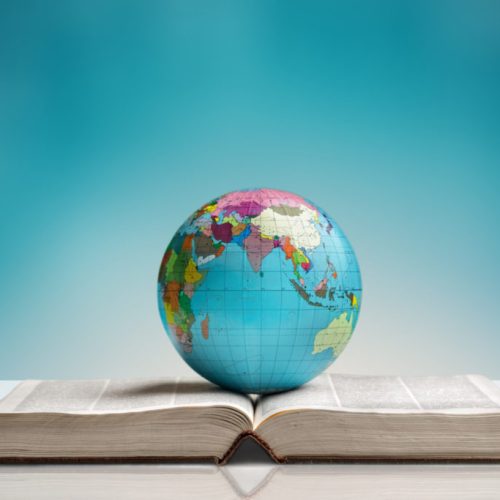 Heavy book and globe on background